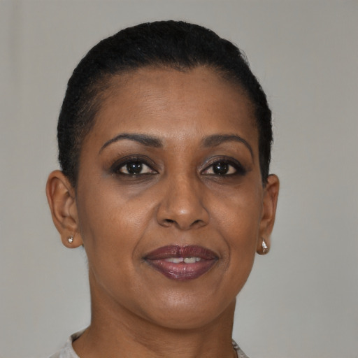 Joyful black adult female with short  brown hair and brown eyes