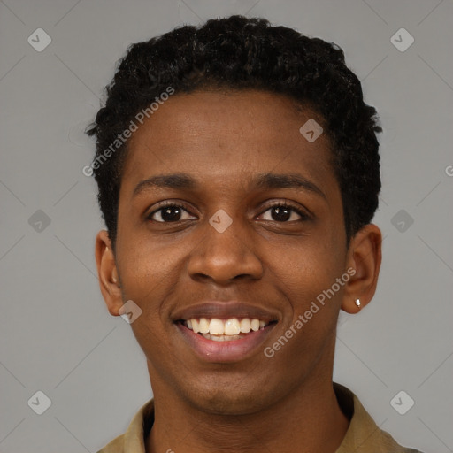 Joyful black young-adult male with short  black hair and brown eyes