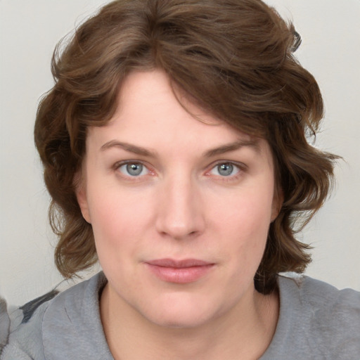 Joyful white young-adult female with medium  brown hair and blue eyes