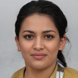 Joyful latino young-adult female with medium  brown hair and brown eyes