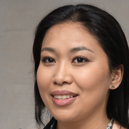 Joyful asian young-adult female with medium  black hair and brown eyes