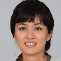 Joyful asian young-adult female with medium  black hair and brown eyes