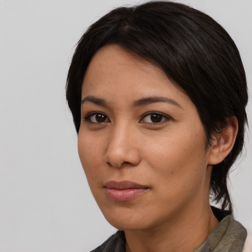 Joyful asian young-adult female with short  black hair and brown eyes