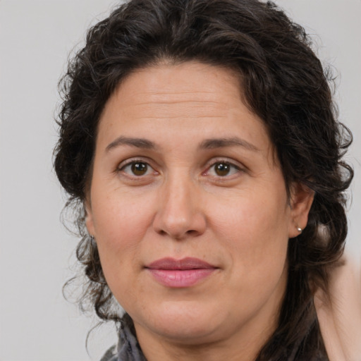 Joyful white adult female with medium  brown hair and brown eyes