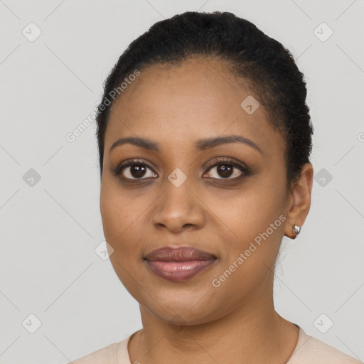 Joyful black young-adult female with short  black hair and brown eyes