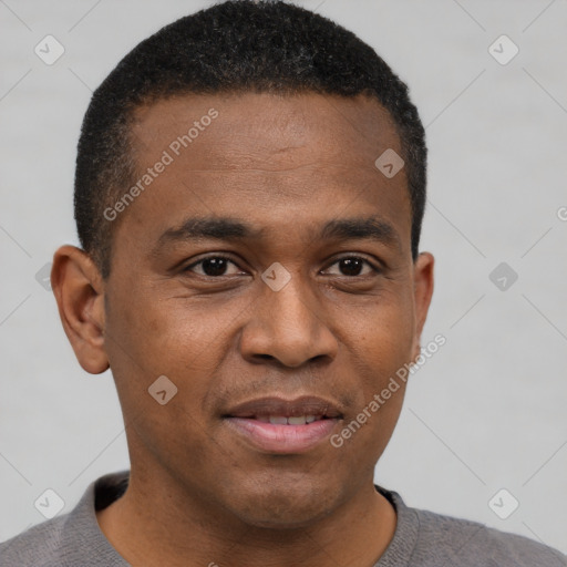 Joyful black young-adult male with short  brown hair and brown eyes