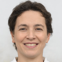 Joyful white adult female with short  brown hair and brown eyes