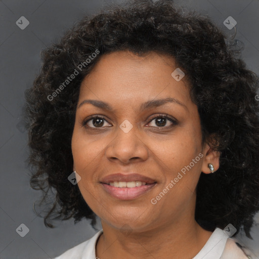 Joyful black adult female with medium  brown hair and brown eyes
