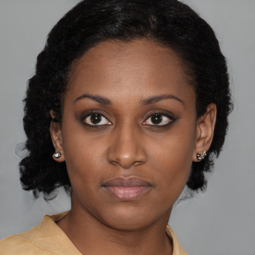 Neutral black young-adult female with medium  brown hair and brown eyes