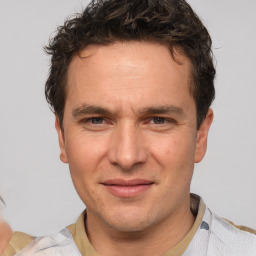 Joyful white adult male with short  brown hair and brown eyes