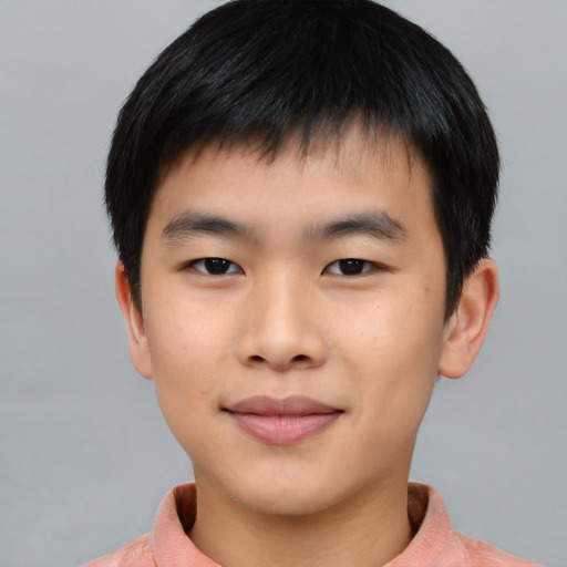 Joyful asian child male with short  black hair and brown eyes