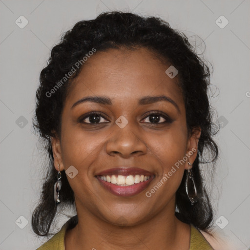 Joyful black young-adult female with long  brown hair and brown eyes