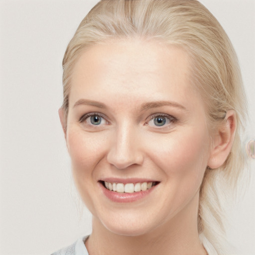 Joyful white young-adult female with medium  brown hair and blue eyes