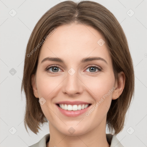 Joyful white young-adult female with medium  brown hair and green eyes