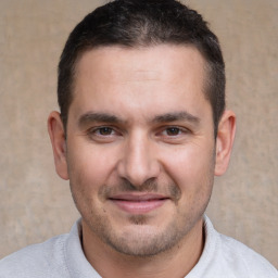 Joyful white young-adult male with short  brown hair and brown eyes