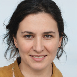 Joyful white adult female with medium  brown hair and brown eyes