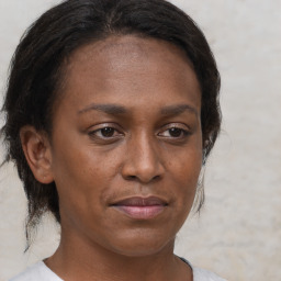 Joyful black young-adult female with medium  brown hair and brown eyes