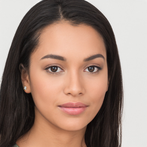 Joyful latino young-adult female with long  brown hair and brown eyes