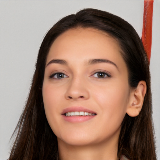 Joyful white young-adult female with long  brown hair and brown eyes