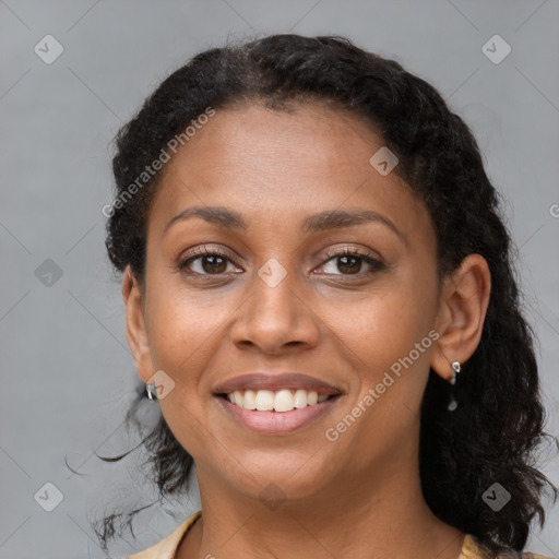 Joyful black young-adult female with medium  brown hair and brown eyes