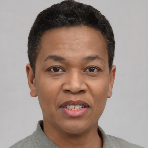 Joyful black adult male with short  brown hair and brown eyes