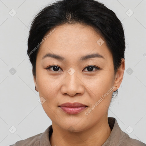 Joyful asian young-adult female with medium  brown hair and brown eyes