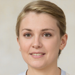 Joyful white young-adult female with short  brown hair and grey eyes