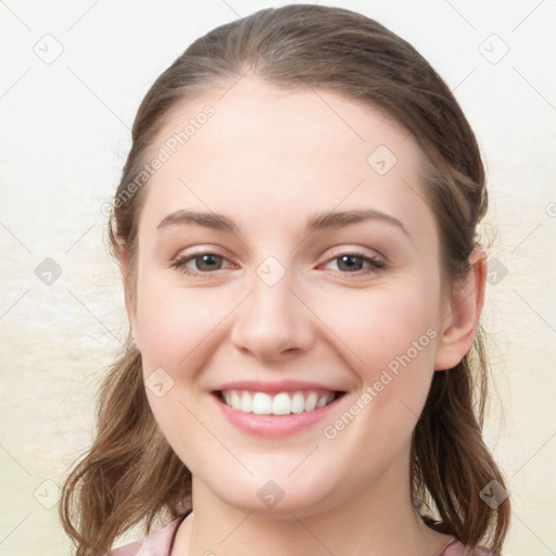 Joyful white young-adult female with long  brown hair and blue eyes