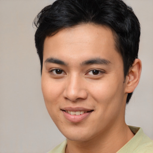 Joyful asian young-adult male with short  brown hair and brown eyes