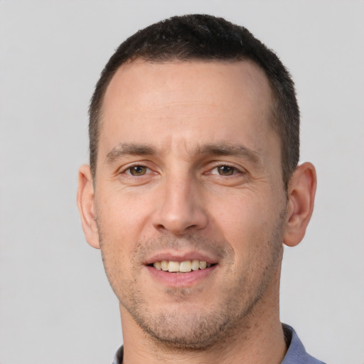 Joyful white adult male with short  brown hair and brown eyes