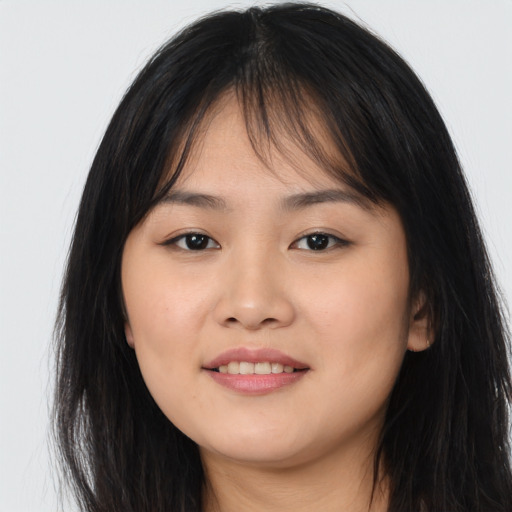 Joyful asian young-adult female with long  brown hair and brown eyes