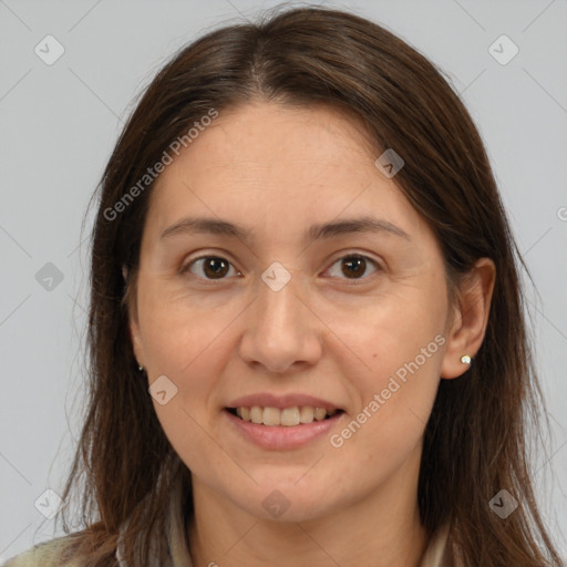 Joyful white adult female with long  brown hair and brown eyes