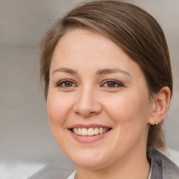 Joyful white adult female with medium  brown hair and brown eyes