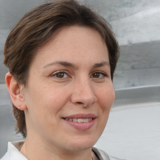 Joyful white adult female with medium  brown hair and brown eyes