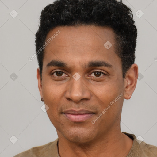 Joyful black young-adult male with short  black hair and brown eyes