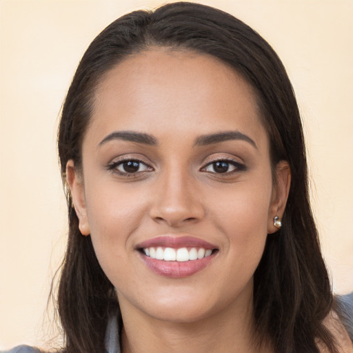 Joyful white young-adult female with long  brown hair and brown eyes