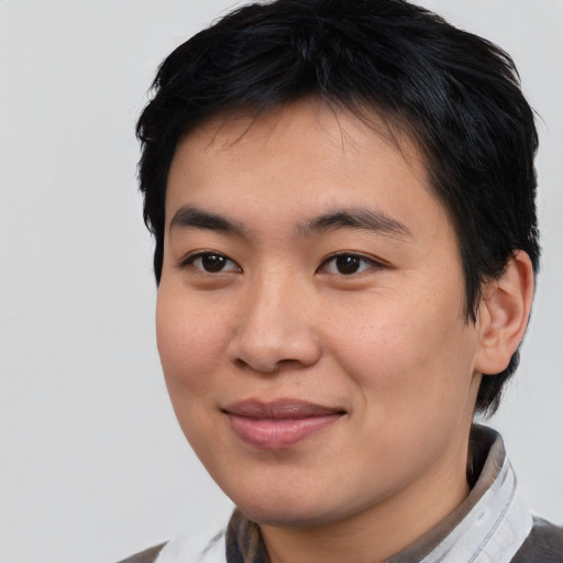 Joyful asian young-adult male with short  black hair and brown eyes