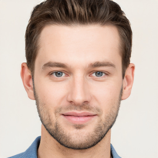 Joyful white young-adult male with short  brown hair and grey eyes