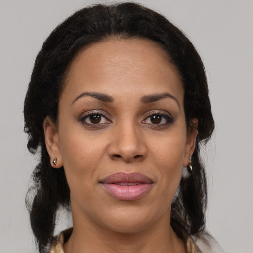 Joyful black young-adult female with medium  brown hair and brown eyes
