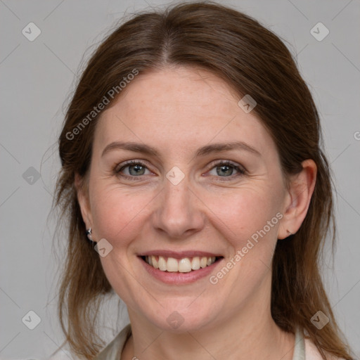 Joyful white adult female with medium  brown hair and grey eyes