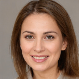 Joyful white young-adult female with medium  brown hair and brown eyes