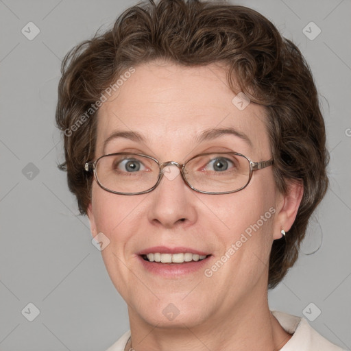 Joyful white adult female with medium  brown hair and blue eyes