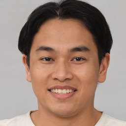 Joyful asian young-adult male with short  brown hair and brown eyes