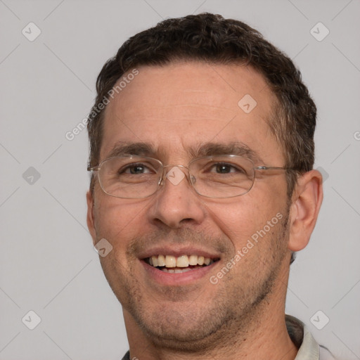 Joyful white adult male with short  brown hair and brown eyes