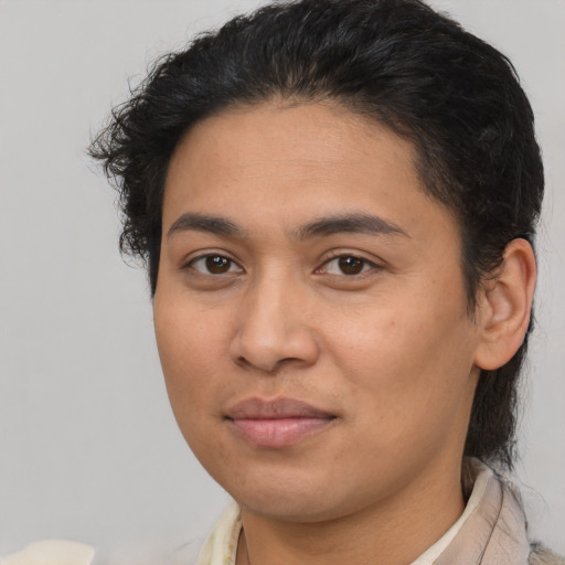 Joyful latino young-adult female with short  brown hair and brown eyes