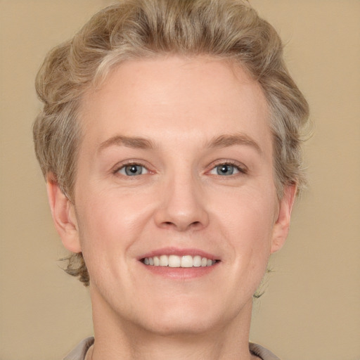 Joyful white adult male with short  brown hair and grey eyes