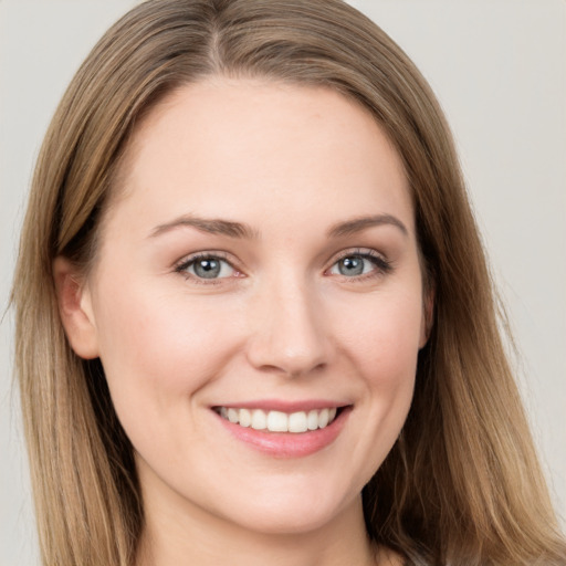 Joyful white young-adult female with long  brown hair and grey eyes