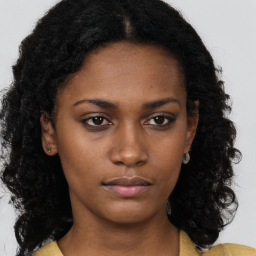 Neutral black young-adult female with long  brown hair and brown eyes