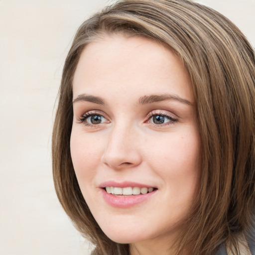 Joyful white young-adult female with long  brown hair and blue eyes