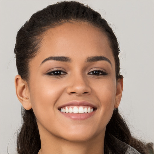 Joyful white young-adult female with long  brown hair and brown eyes